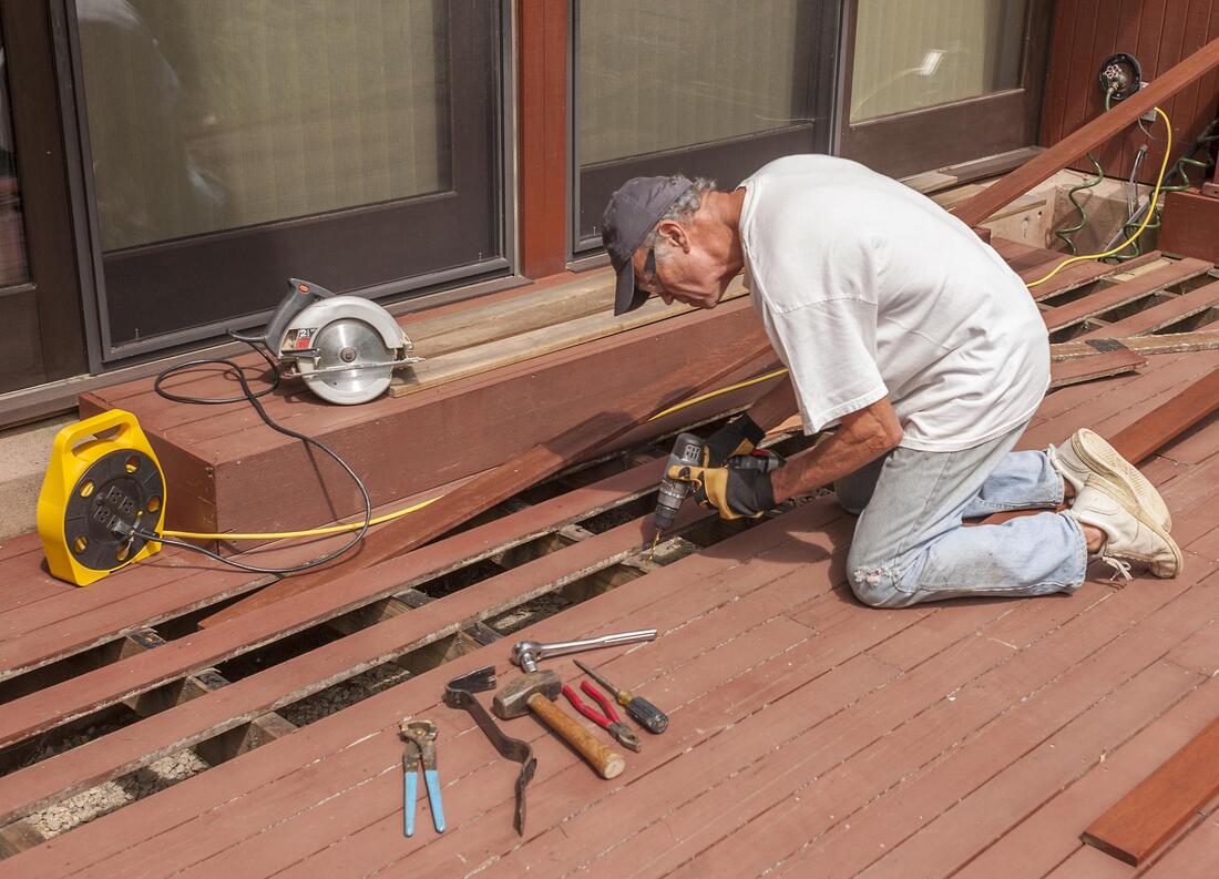man repairing a deck