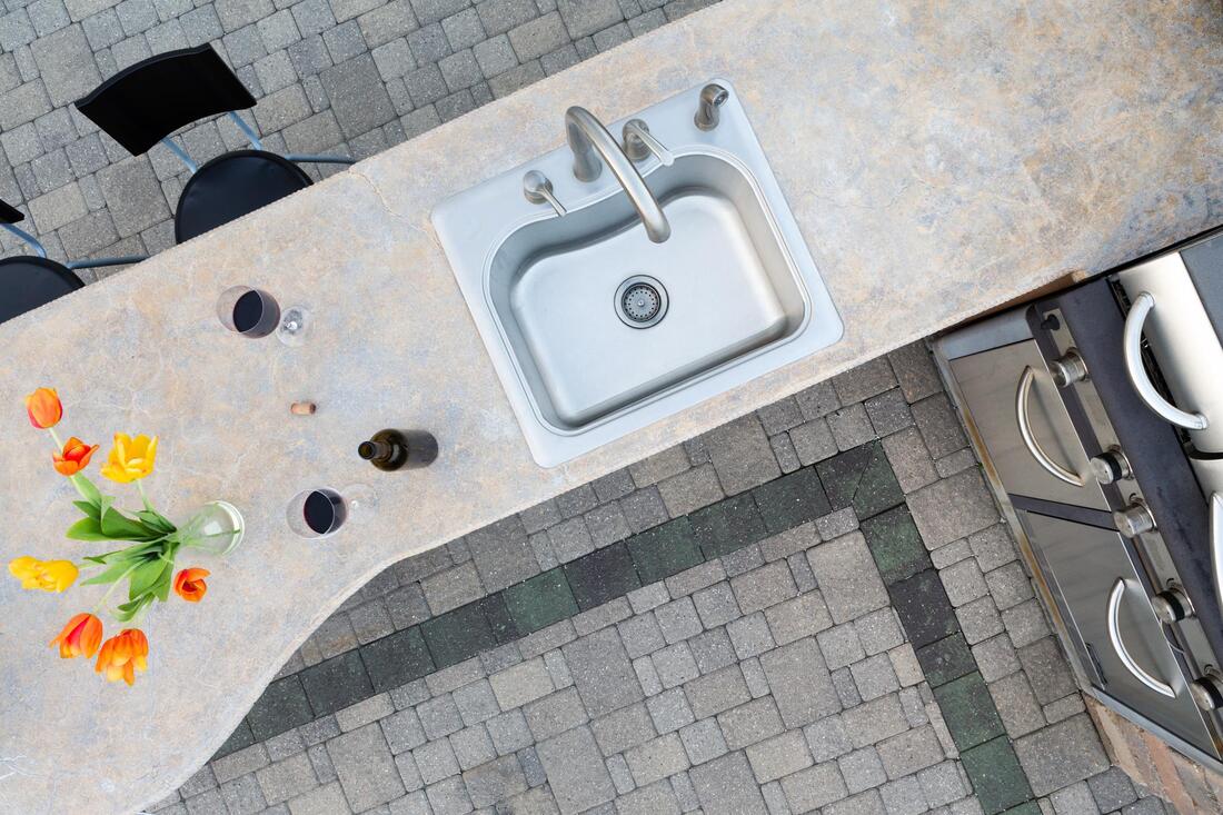 an outside kitchen with a sink